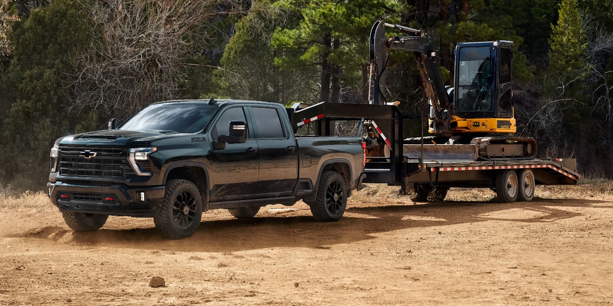 A Chevrolet Silverado HD Trail Boss with a gooseneck trailer carrying an excavator